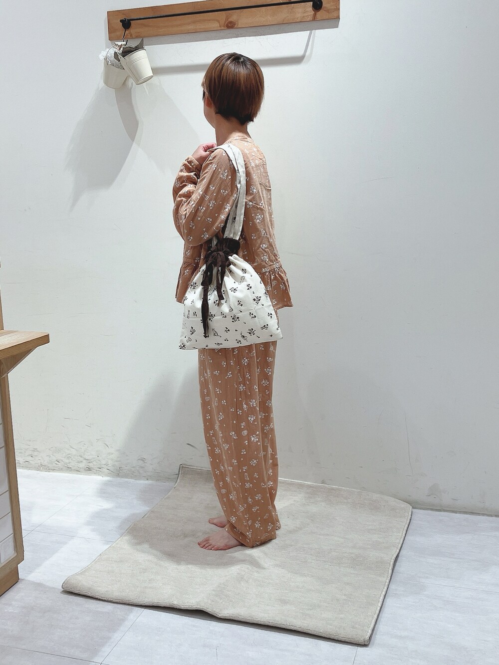 オレンジ系のシャツ/ブラウス、オレンジ系のパンツ、ホワイト系のバッグを着用したレディースの秋コーディネートの2枚目の写真