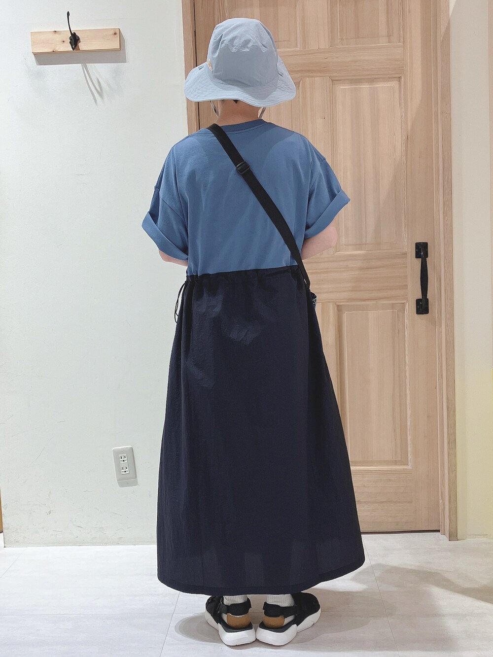 ブルー系のワンピース、ブルー系のショルダーバッグ、ブラック系のサンダルを着用したレディースの春コーディネートの3枚目の写真