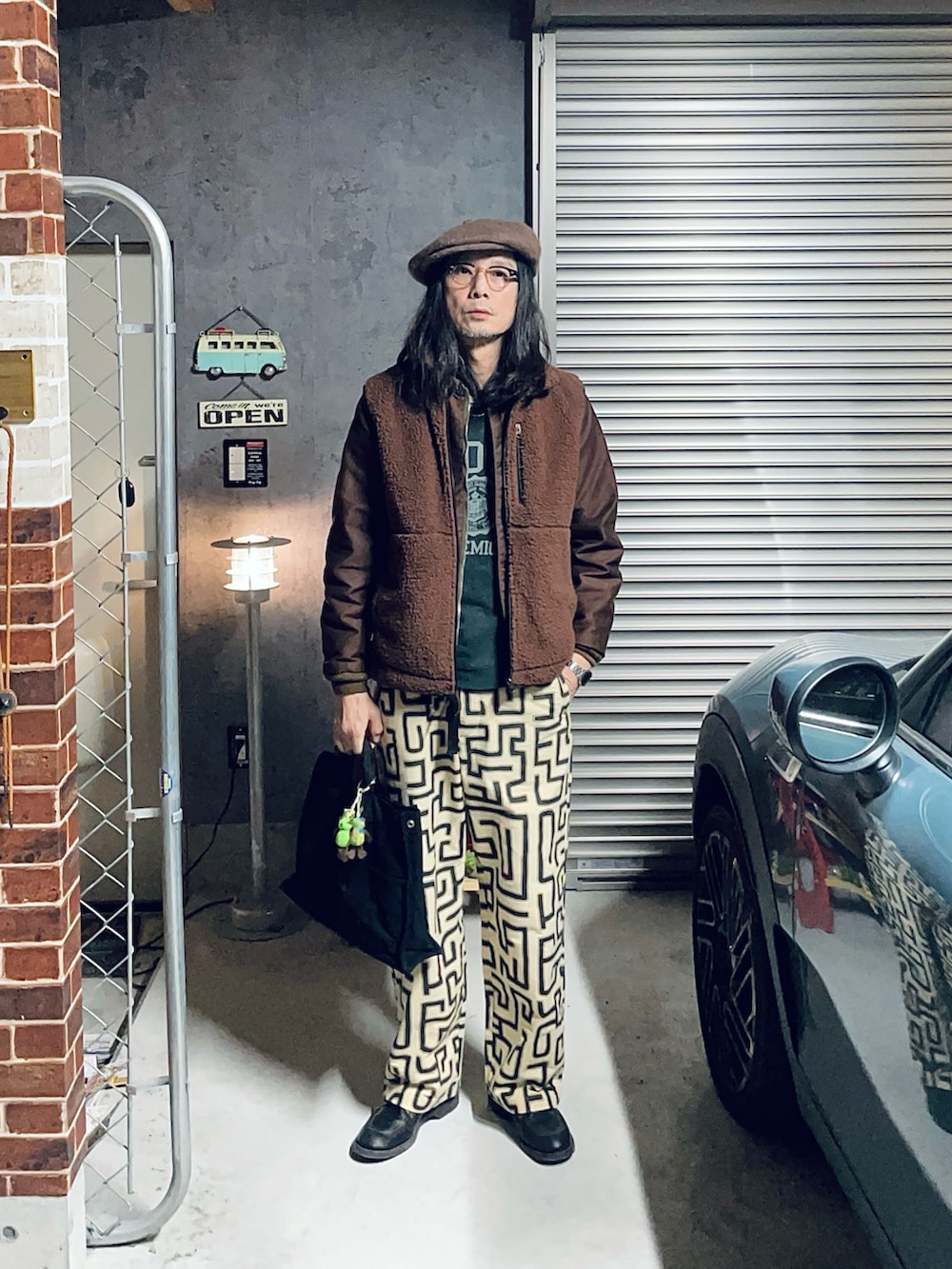 ブラウン系のミリタリージャケット、ベージュ系のその他パンツ、ブラック系のブーツを着用したメンズの冬コーディネートの2枚目の写真