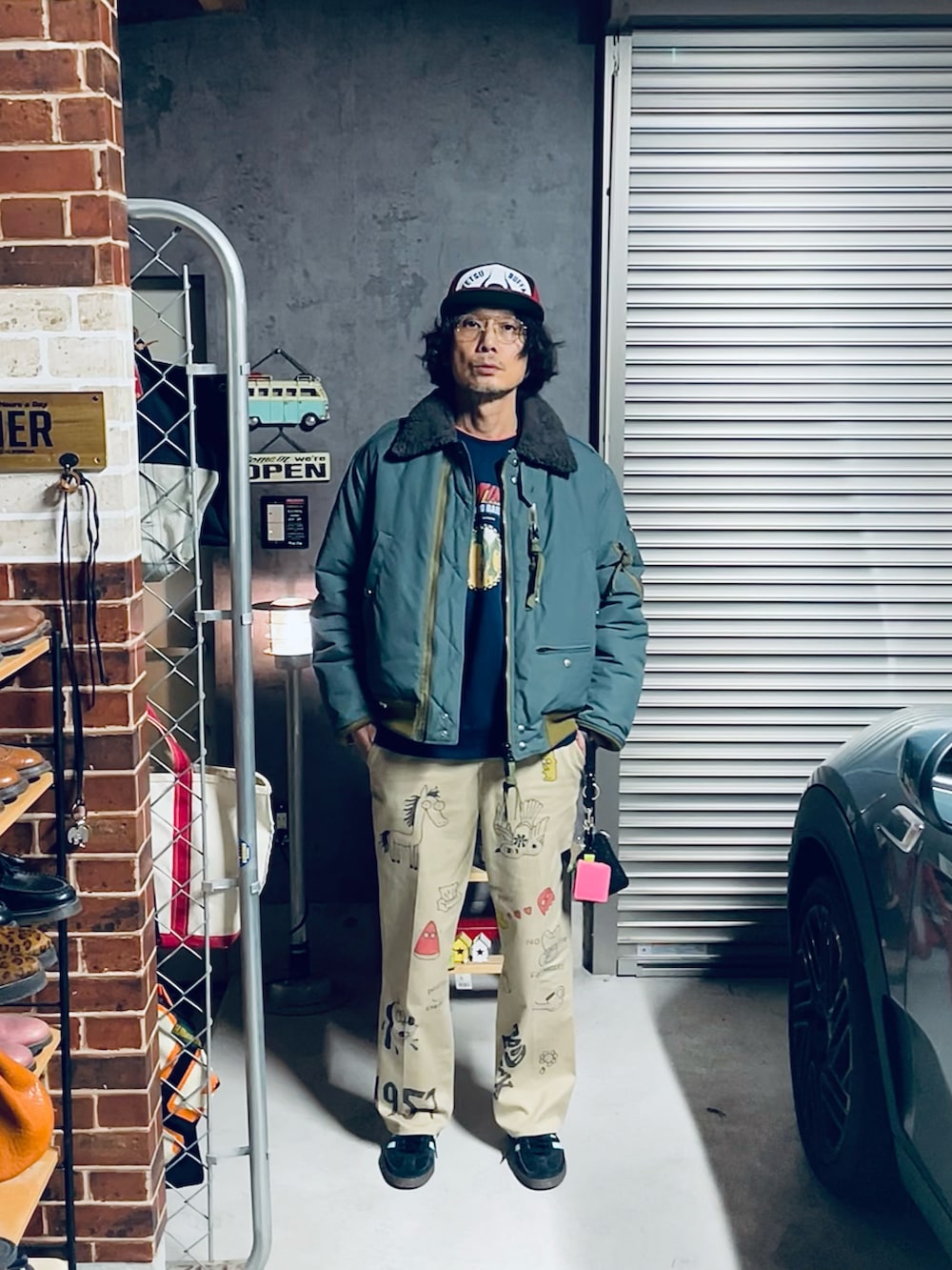 ベージュ系のブルゾン、ブラック系のスニーカー、ベージュ系のチノパンツを着用したメンズの冬コーディネートの2枚目の写真