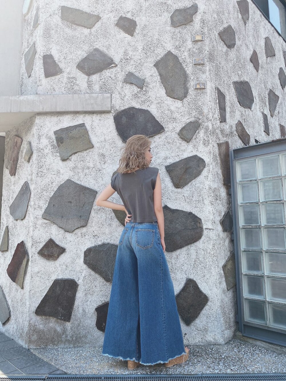 ブルー系のデニムパンツ、グレー系のTシャツ/カットソーを着用したレディースの夏コーディネートの4枚目の写真