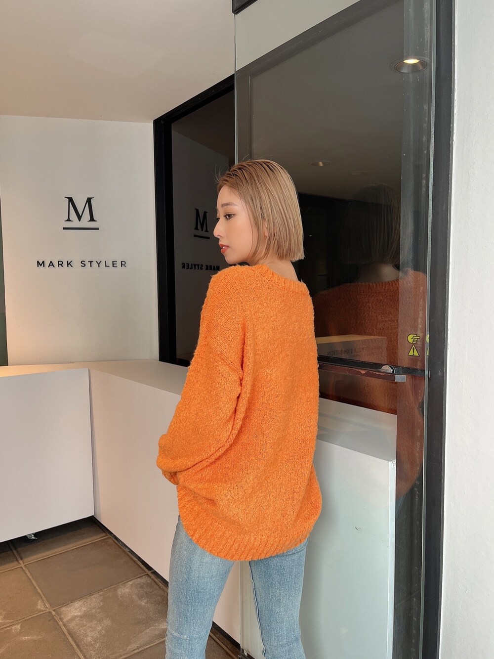 ブルー系のデニムパンツ、ホワイト系のパンプスを着用したレディースの冬コーディネートの4枚目の写真