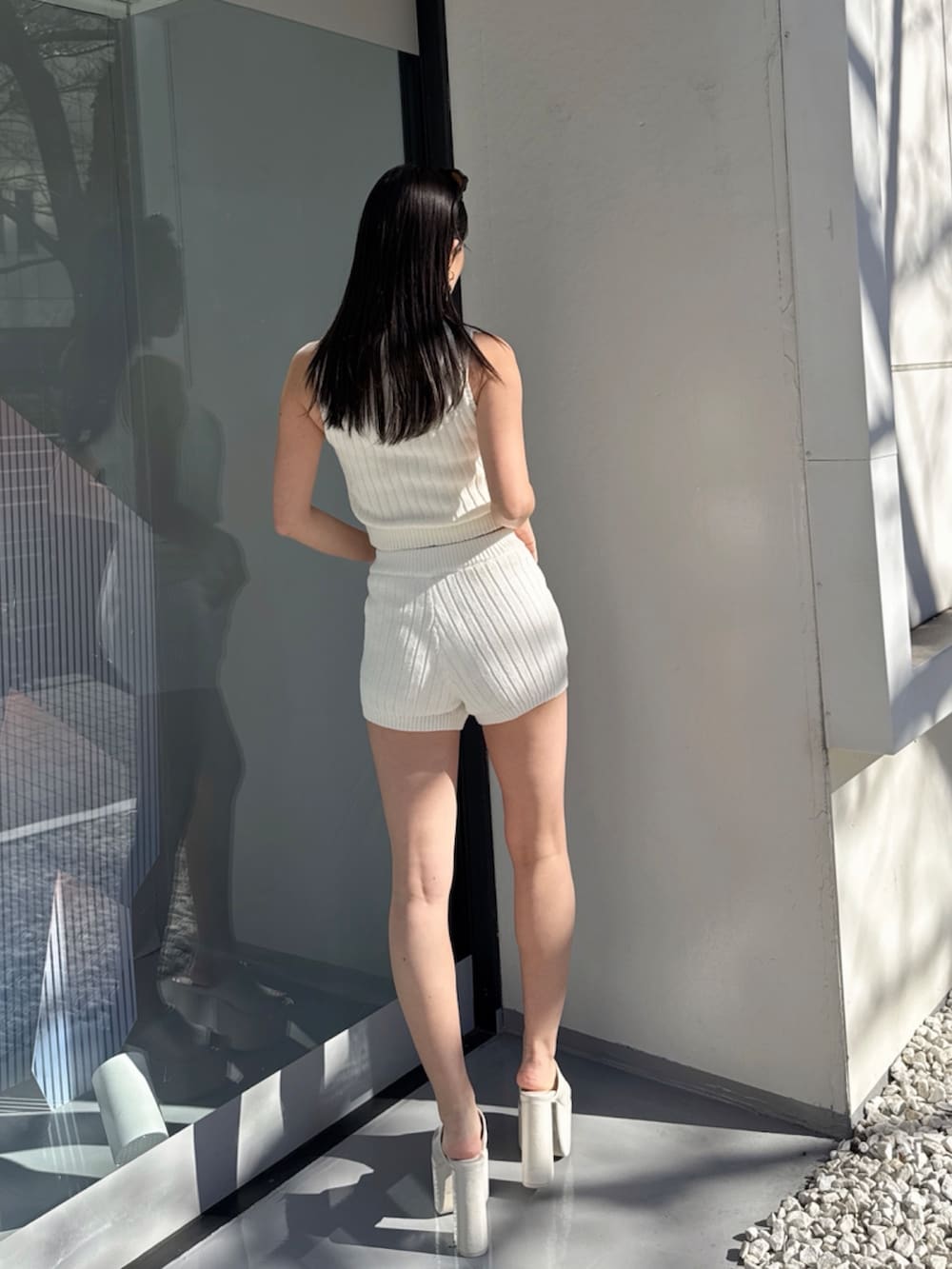 ホワイト系のニット/セーターを着用したレディースの夏コーディネートの3枚目の写真