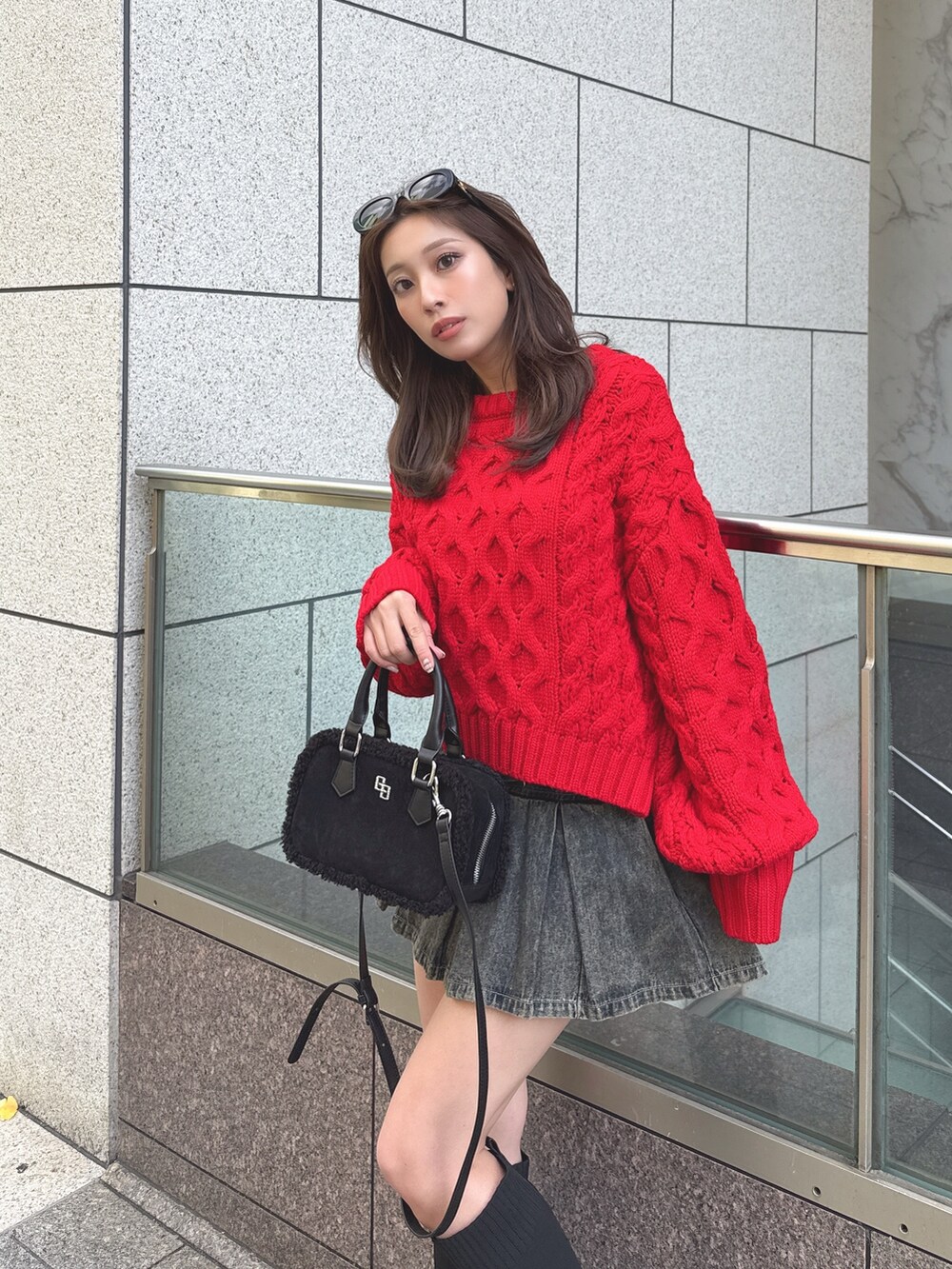 ブルー系のデニムスカート、レッド系のニット/セーターを着用したレディースの冬コーディネートの3枚目の写真