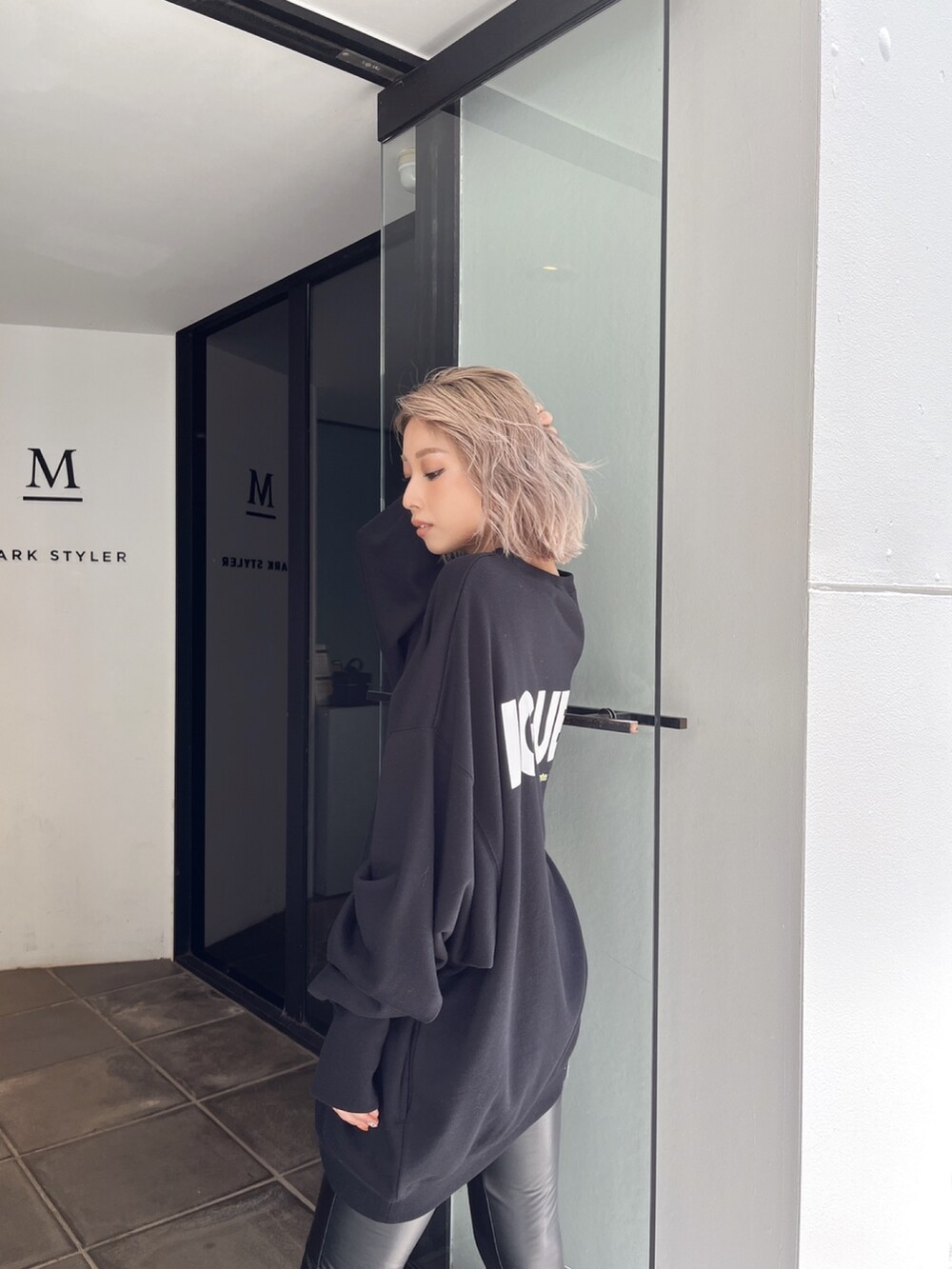 ブラック系のスウェット、ブラック系のブーツを着用したレディースの冬コーディネートの5枚目の写真