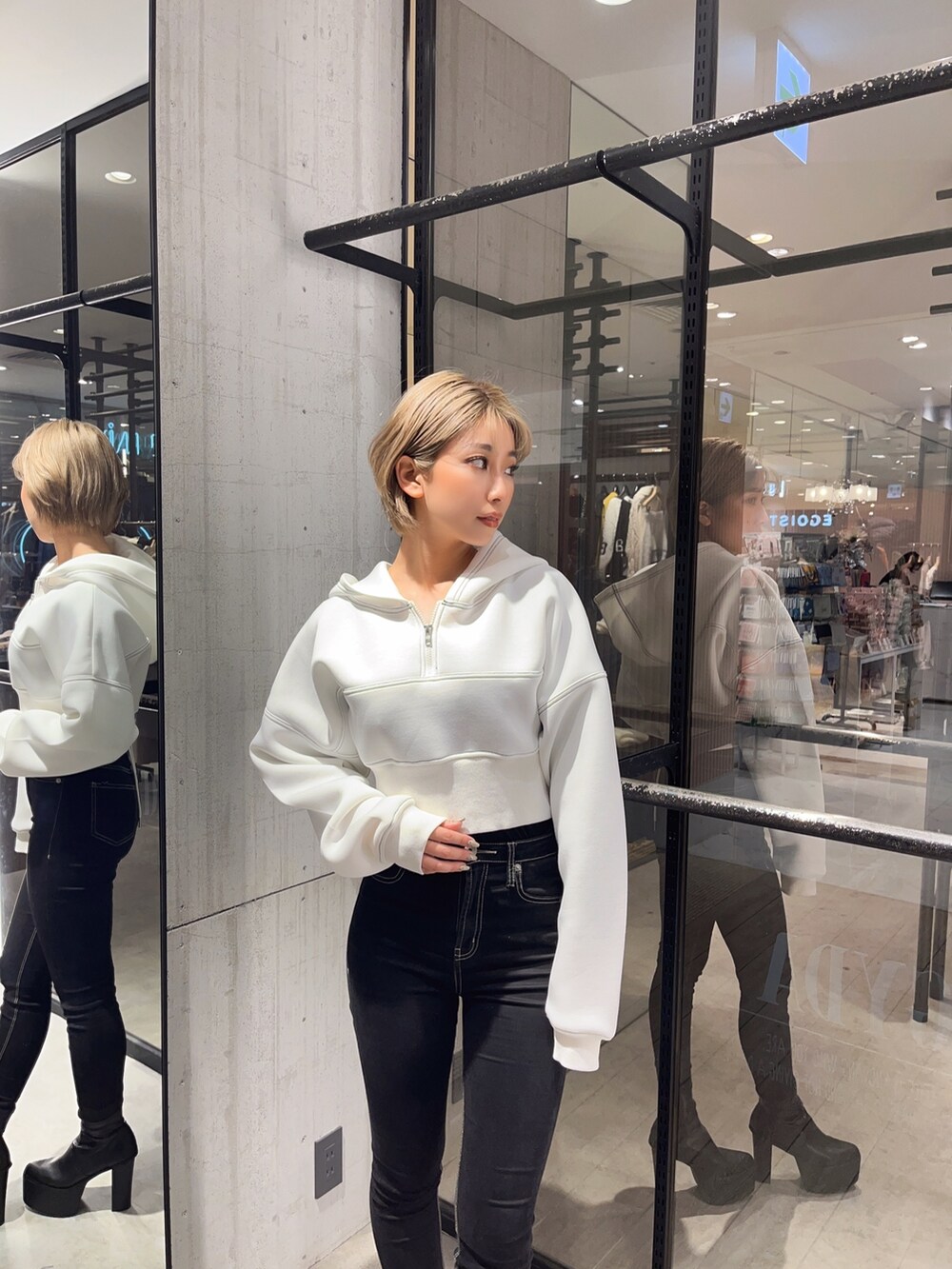 ブラック系のデニムパンツ、ホワイト系のパーカーを着用したレディースの冬コーディネートの4枚目の写真