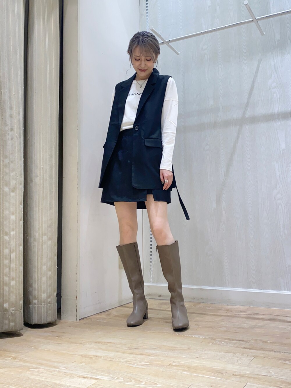 ブラック系のベスト、ブラック系のその他パンツ、ホワイト系のTシャツ/カットソーを着用したレディースの秋コーディネートの2枚目の写真