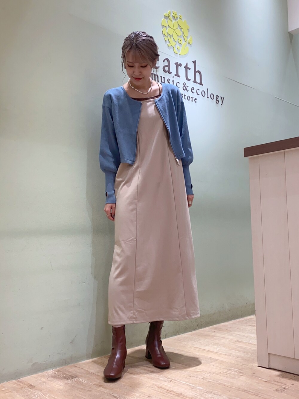 ブルー系のカーディガン/ボレロ、ベージュ系のワンピースを着用したレディースの秋コーディネートの2枚目の写真