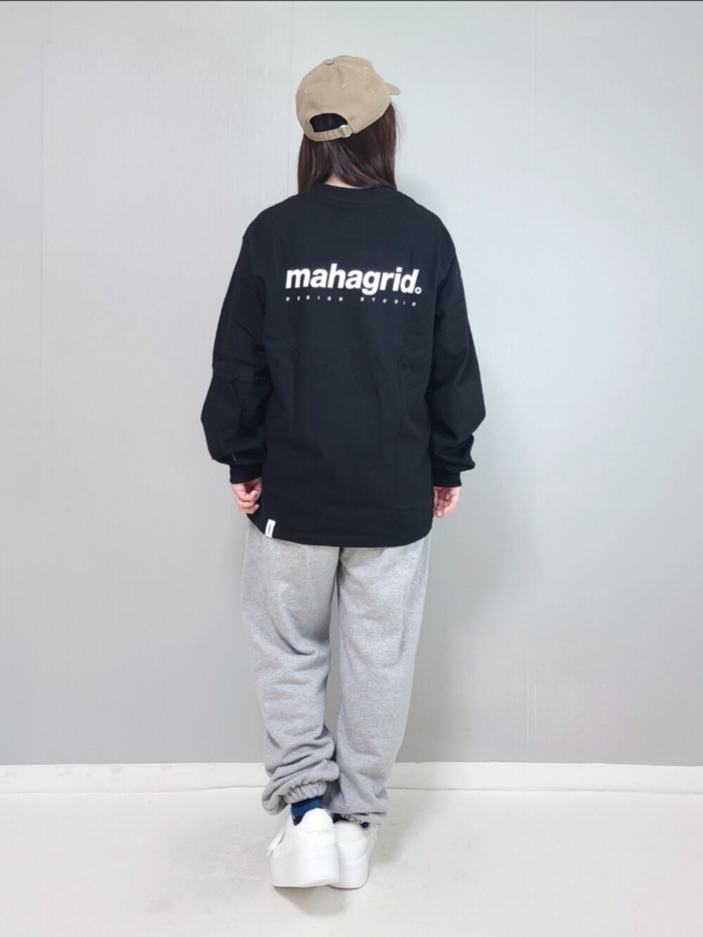 ブラック系のTシャツ/カットソー、グレー系のスウェットパンツ、ホワイト系のスニーカーを着用したレディースの冬コーディネートの4枚目の写真
