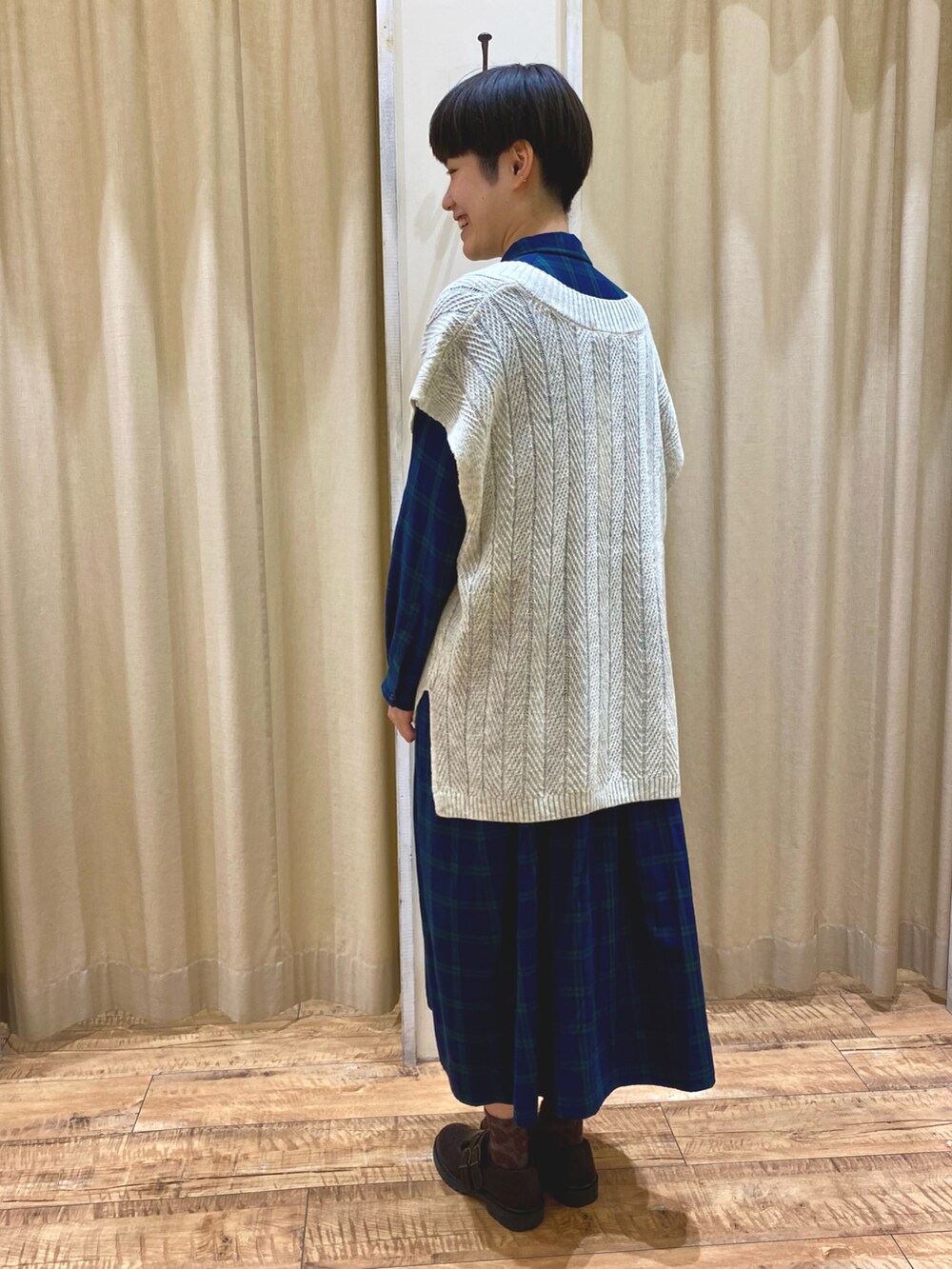 ホワイト系のベスト、グリーン系のワンピース/ドレスを着用したレディースの秋コーディネートの3枚目の写真