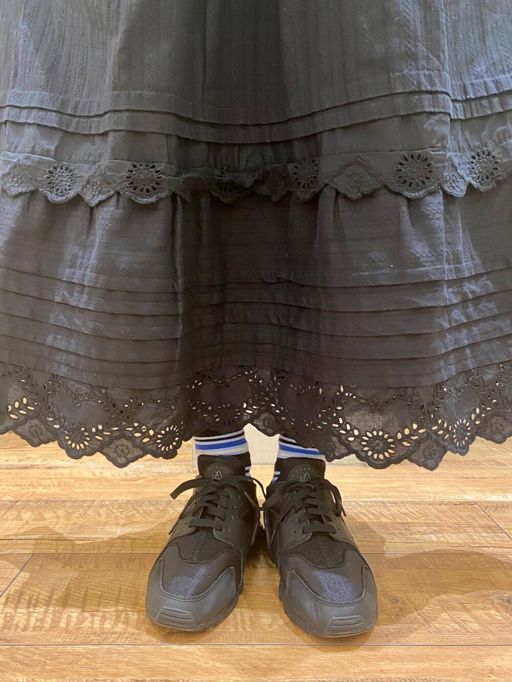 ブルー系のベスト、ブラック系のスカート、ホワイト系のTシャツ/カットソーを着用したレディースの冬コーディネートの5枚目の写真