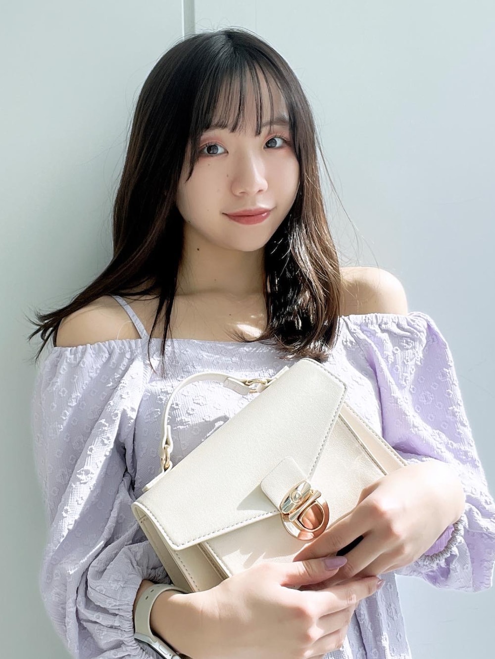 ホワイト系のショルダーバッグ、パープル系のワンピースを着用したレディースの春コーディネートの3枚目の写真