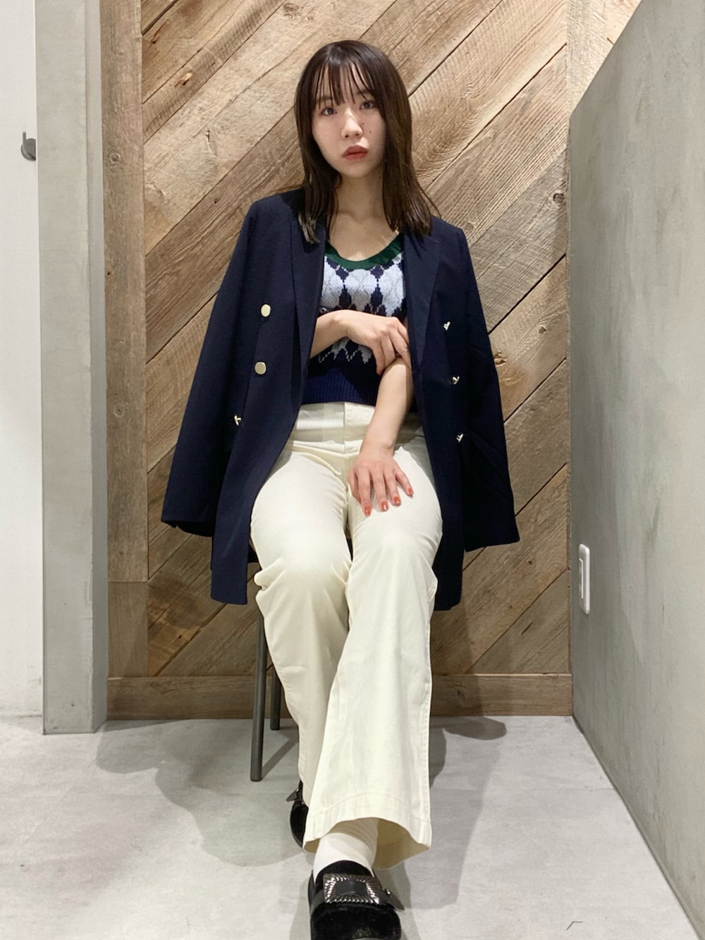 ブルー系のテーラードジャケット、ブルー系のベストを着用したレディースの秋コーディネートの3枚目の写真