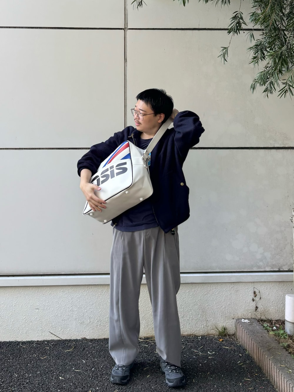 ブルー系のブルゾン、ブルー系のTシャツ/カットソー、ホワイト系のショルダーバッグを着用したメンズの秋コーディネートの2枚目の写真