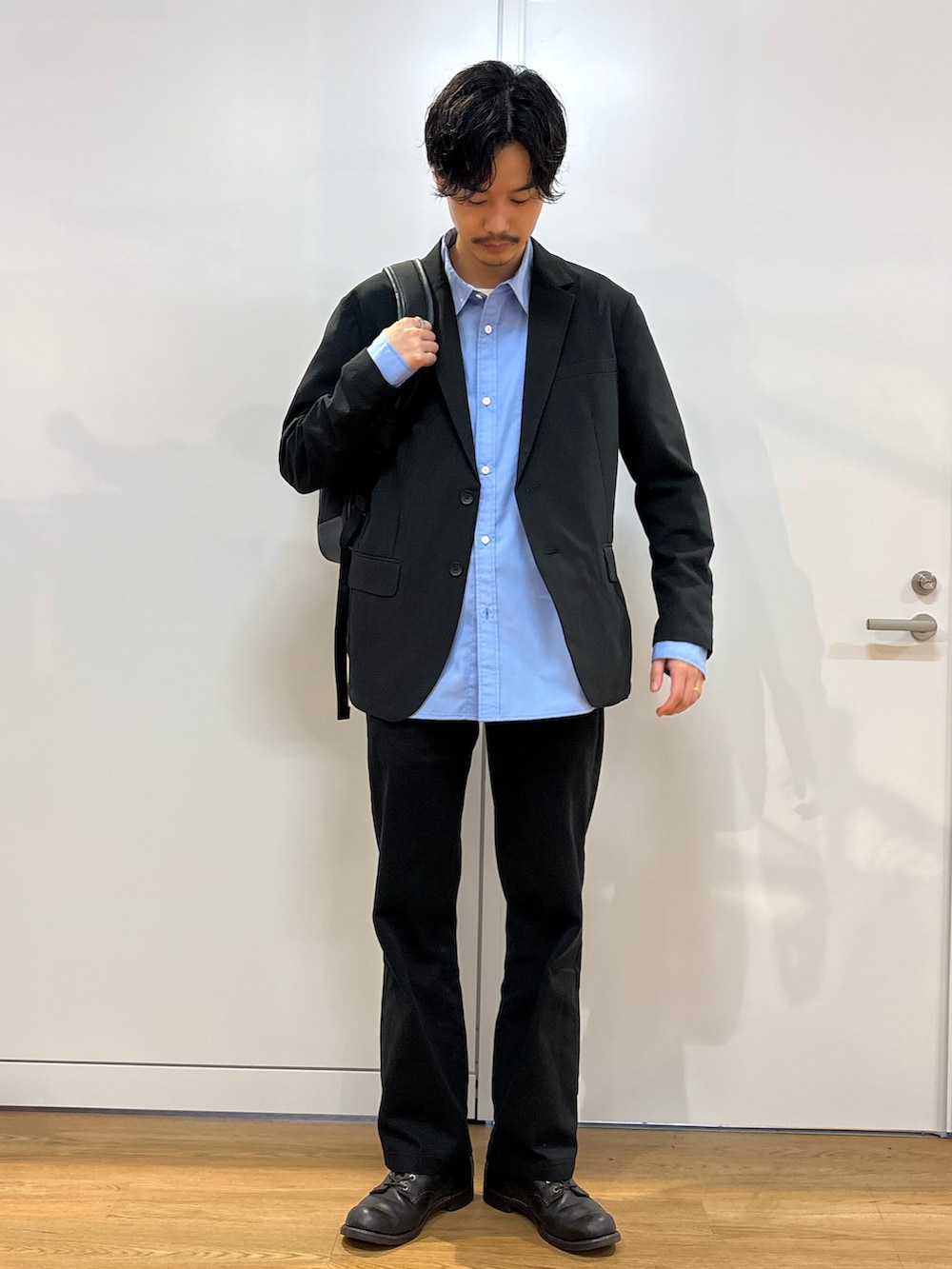 ブラック系のセットアップ、ブルー系のシャツ/ブラウス、ブラック系のバックパック/リュックを着用したメンズの春コーディネートの3枚目の写真