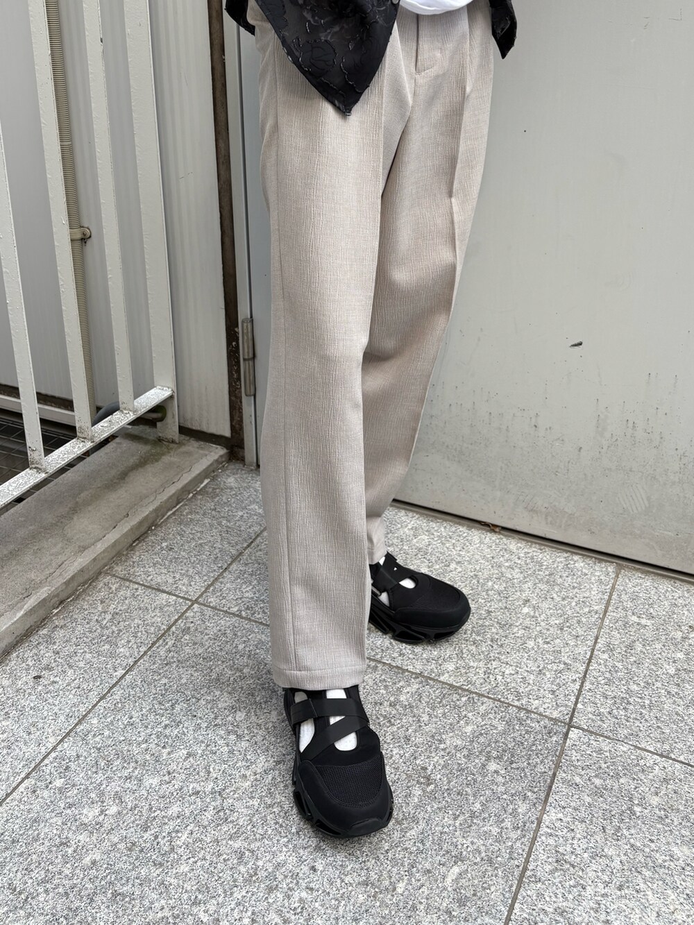 ブラック系のシャツ/ブラウス、ベージュ系のその他パンツ、ブラック系のサンダルを着用したメンズの春コーディネートの4枚目の写真