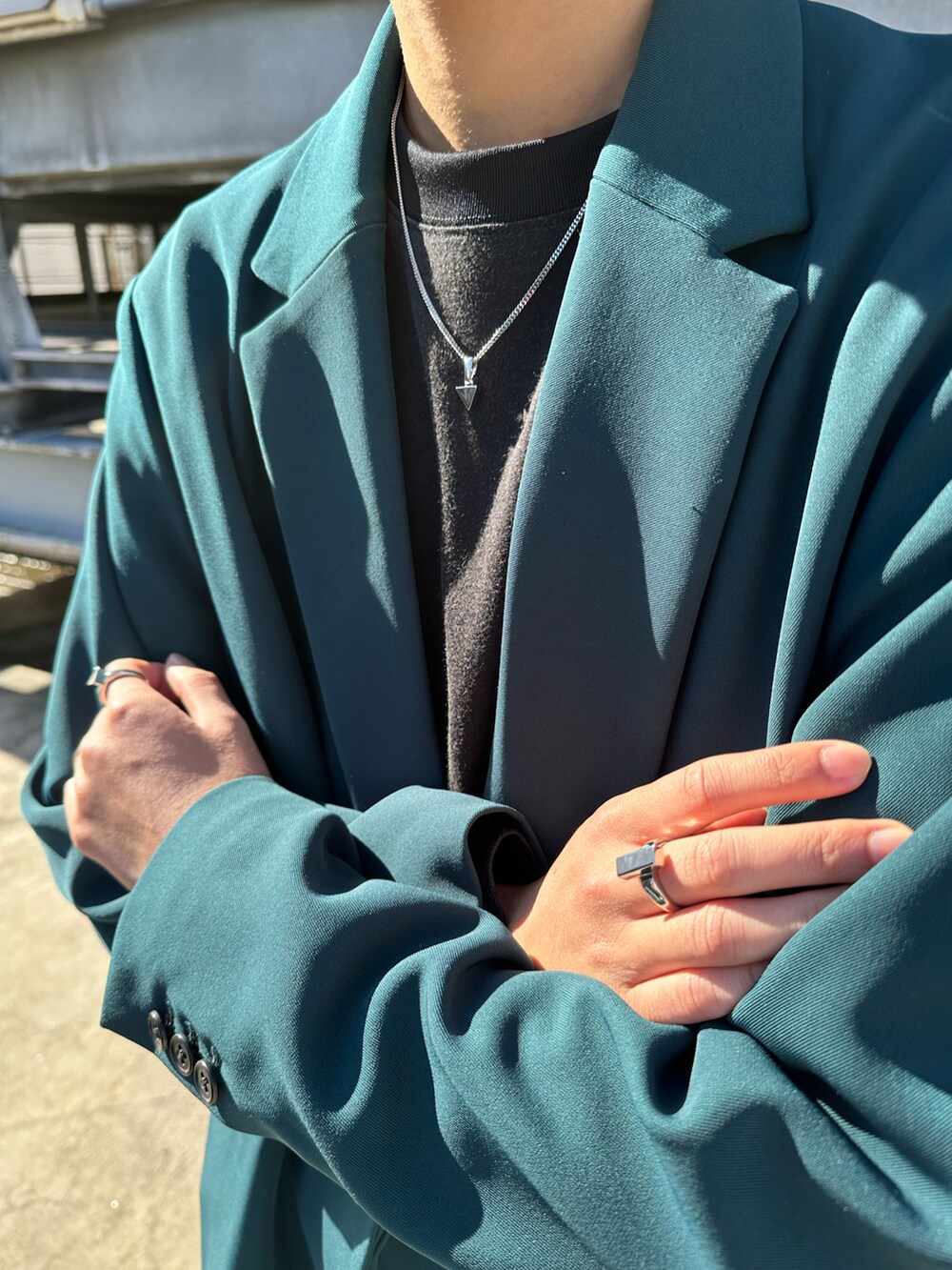 グリーン系のテーラードジャケット、ブラック系のその他パンツ、シルバー系のネックレスを着用したメンズの冬コーディネートの3枚目の写真