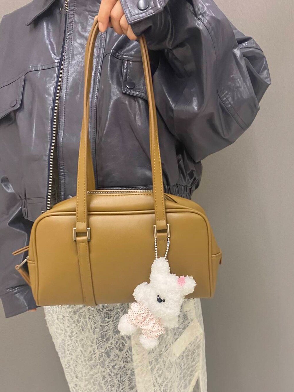 ブルー系のデニムパンツ、ホワイト系のTシャツ/カットソー、グリーン系のボストンバッグを着用したレディースの秋コーディネートの5枚目の写真