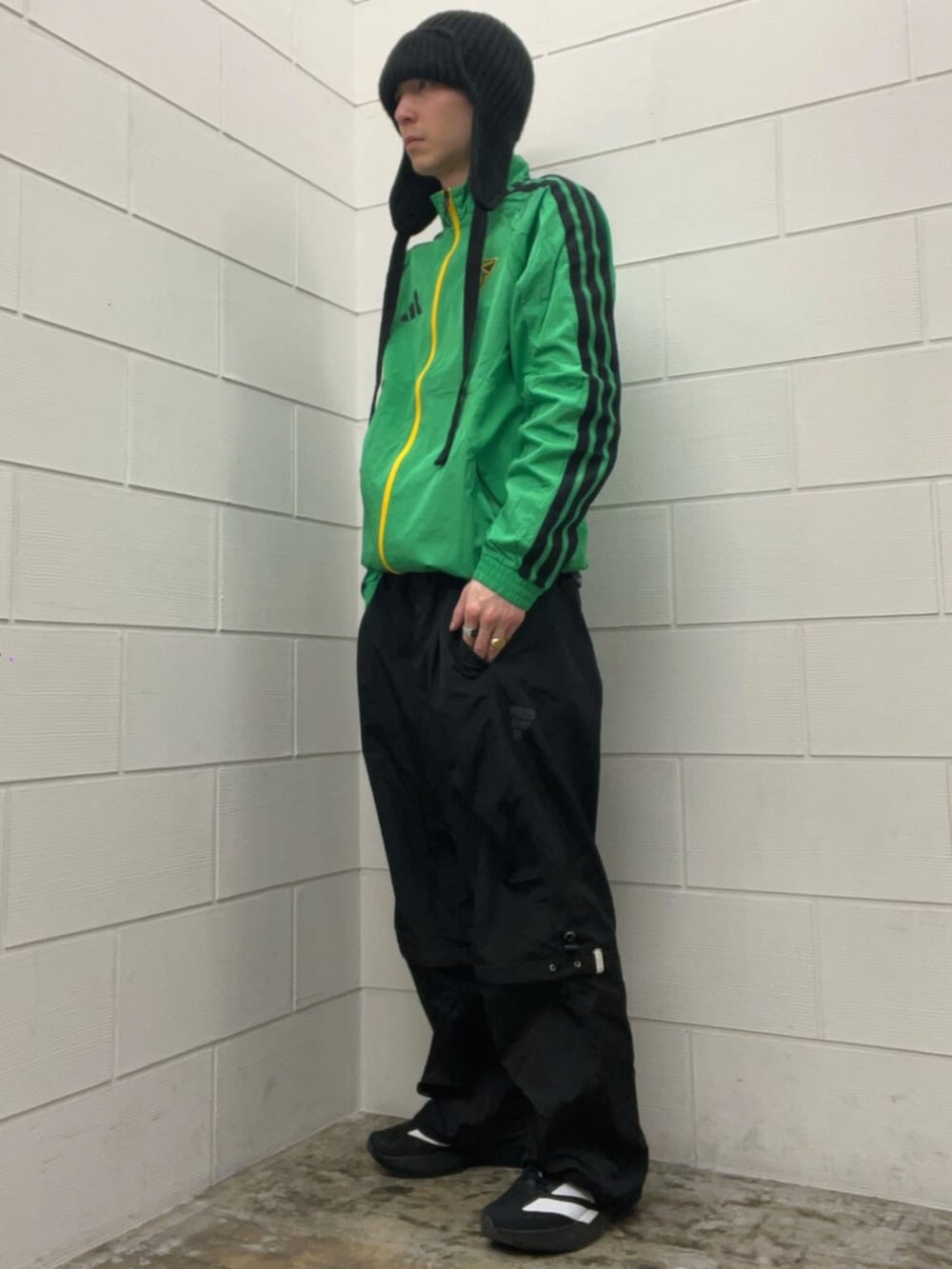 ブラック系のその他パンツ、ブラック系のスニーカー、グリーン系のトップスを着用したメンズの春コーディネートの2枚目の写真