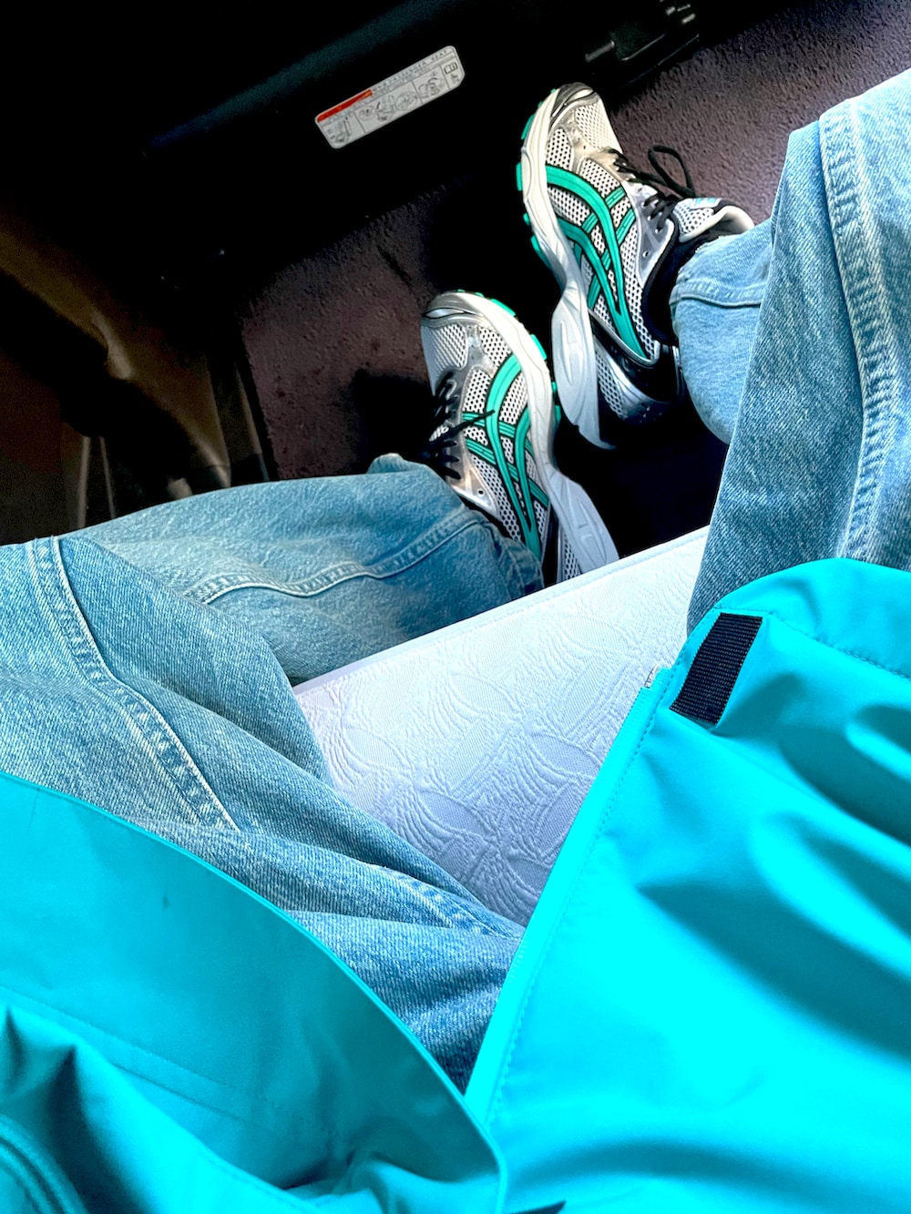 グリーン系のスニーカー、ブルー系のデニムパンツ、グリーン系のマウンテンパーカーを着用したメンズの春コーディネートの3枚目の写真