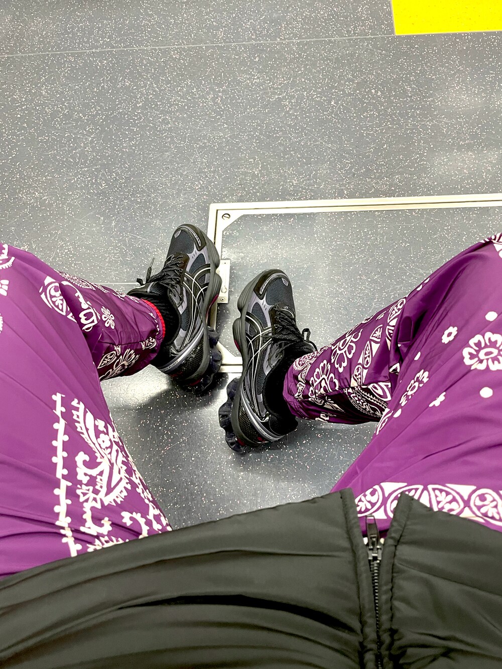 パープル系のその他パンツ、ブラック系のスニーカー、ブラック系のダウンジャケット/コートを着用したメンズの冬コーディネートの2枚目の写真