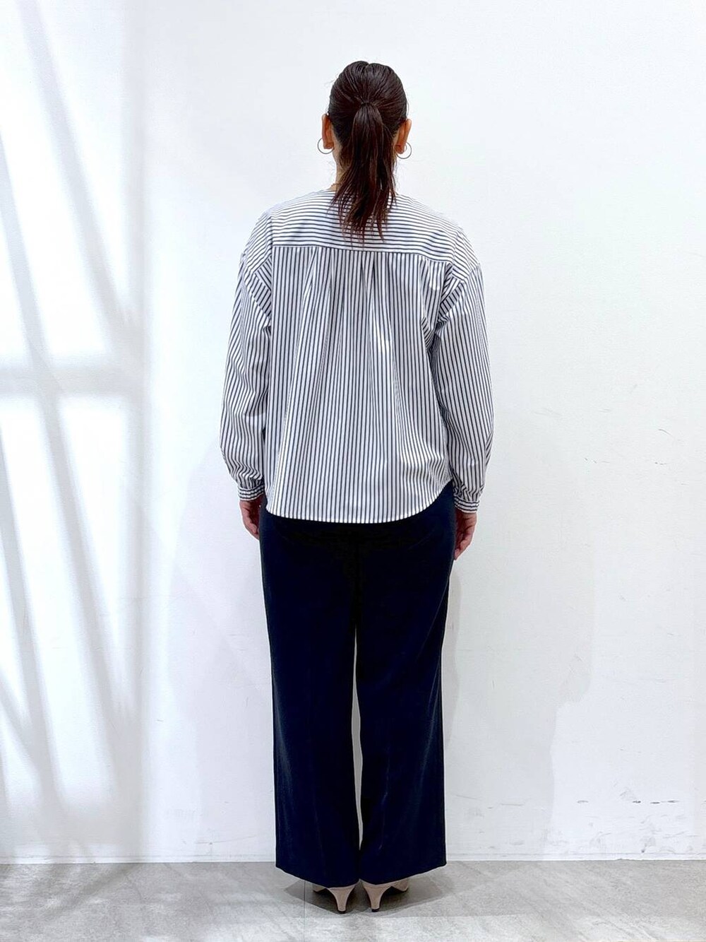 ブルー系のその他パンツ、ベージュ系のパンプス、ホワイト系のハンドバッグを着用したレディースの春コーディネートの4枚目の写真