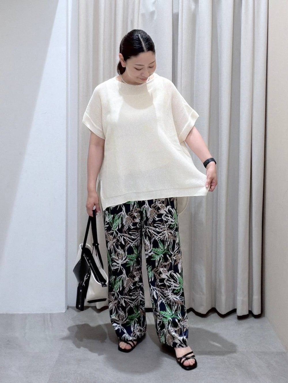 ブラック系のトートバッグ、ホワイト系のサンダル、ブルー系のその他パンツを着用したレディースの夏コーディネートの7枚目の写真