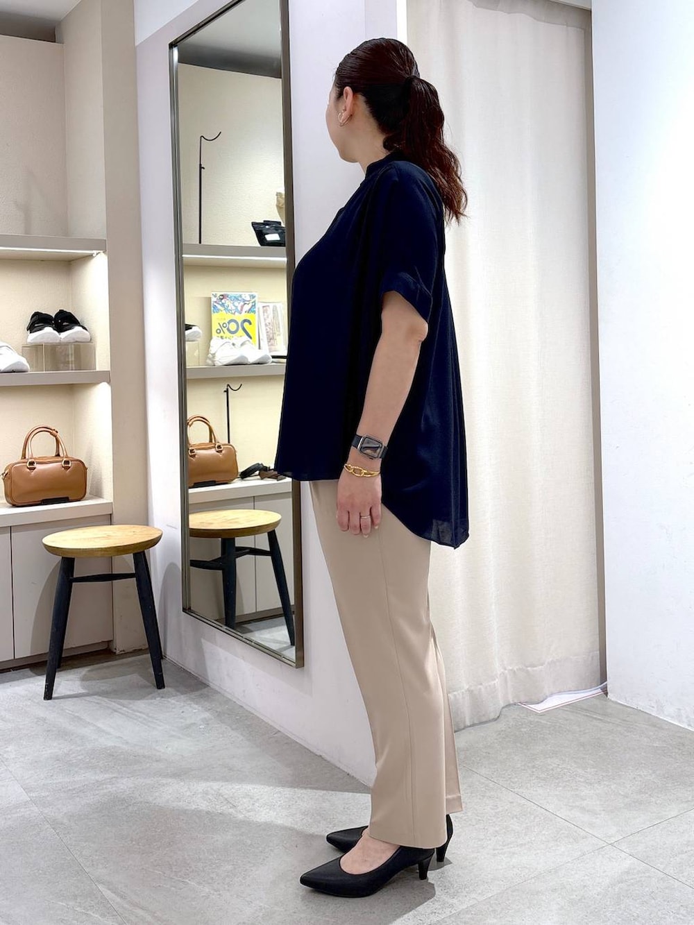 ブラック系のパンプス、ブラック系のハンドバッグ、ベージュ系のその他パンツを着用したレディースの春コーディネートの3枚目の写真