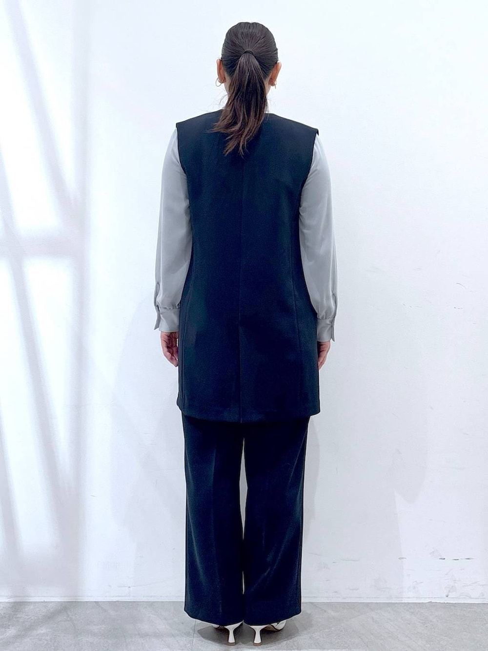 ブルー系のシャツ/ブラウス、ブルー系のその他パンツ、ブルー系のスーツベストを着用したレディースの冬コーディネートの4枚目の写真