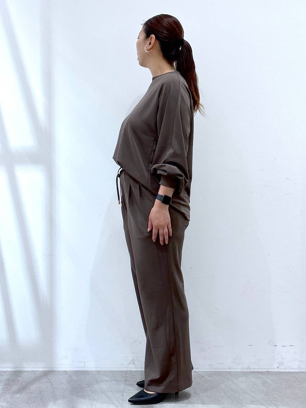 ブラック系のパンプス、ブラウン系のその他パンツ、ブラウン系のTシャツ/カットソーを着用したレディースの秋コーディネートの3枚目の写真