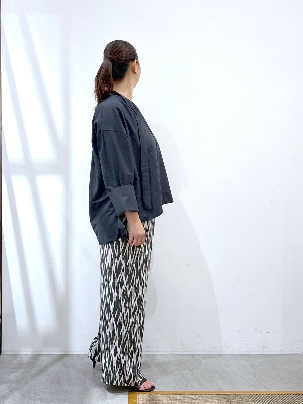 ブルー系のシャツ/ブラウス、ブラック系のトートバッグ、ブラック系のその他パンツを着用したレディースの秋コーディネートの5枚目の写真