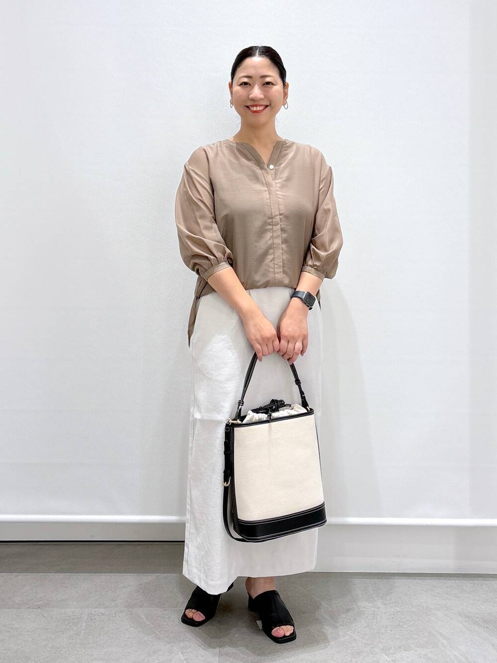 ブラック系のサンダル、グレー系のスカート、ブラウン系のシャツ/ブラウスを着用したレディースの夏コーディネートの2枚目の写真