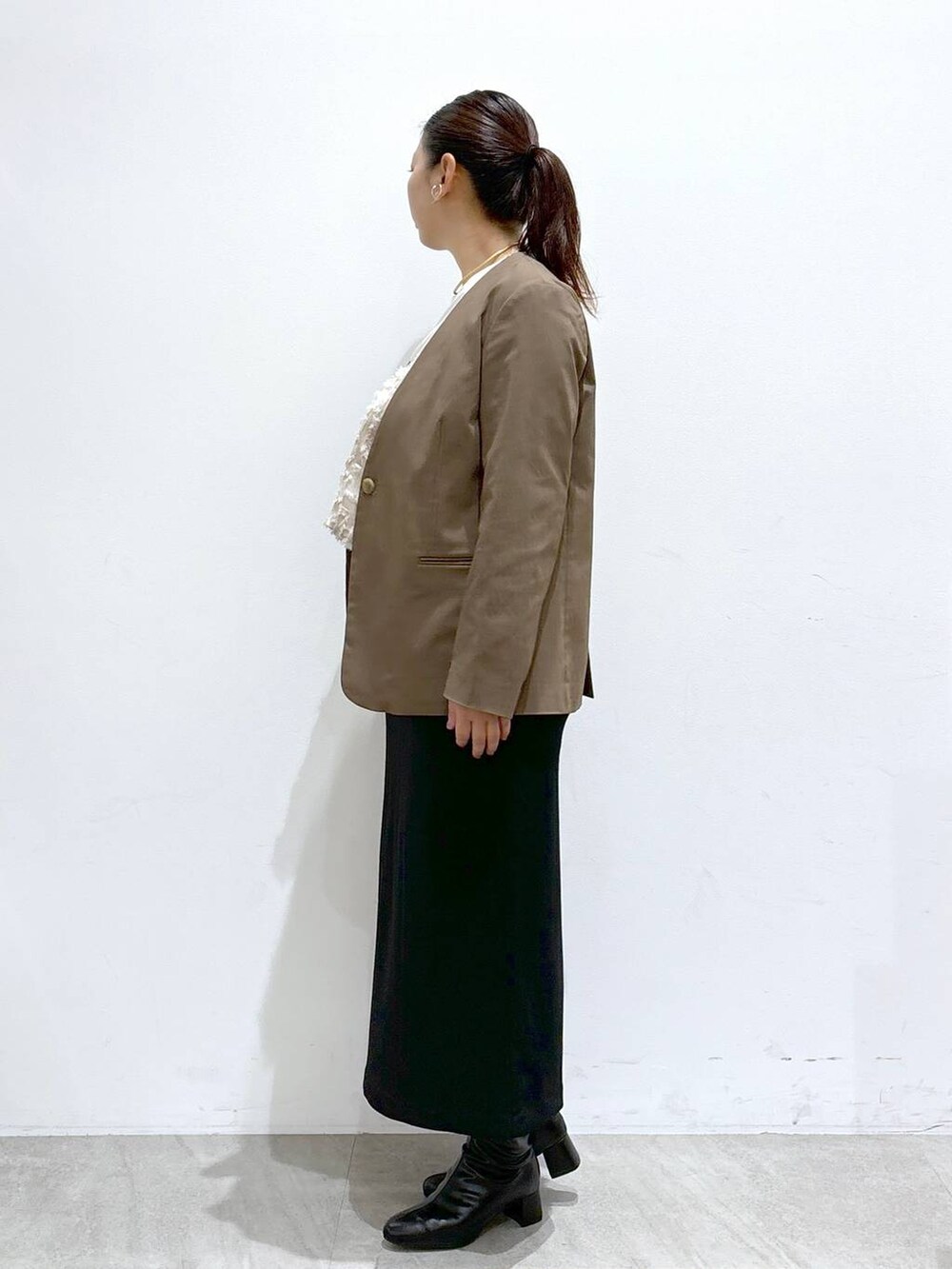 ブラック系のスカート、ブラック系のスカート、ホワイト系のTシャツ/カットソーを着用したレディースの秋コーディネートの3枚目の写真