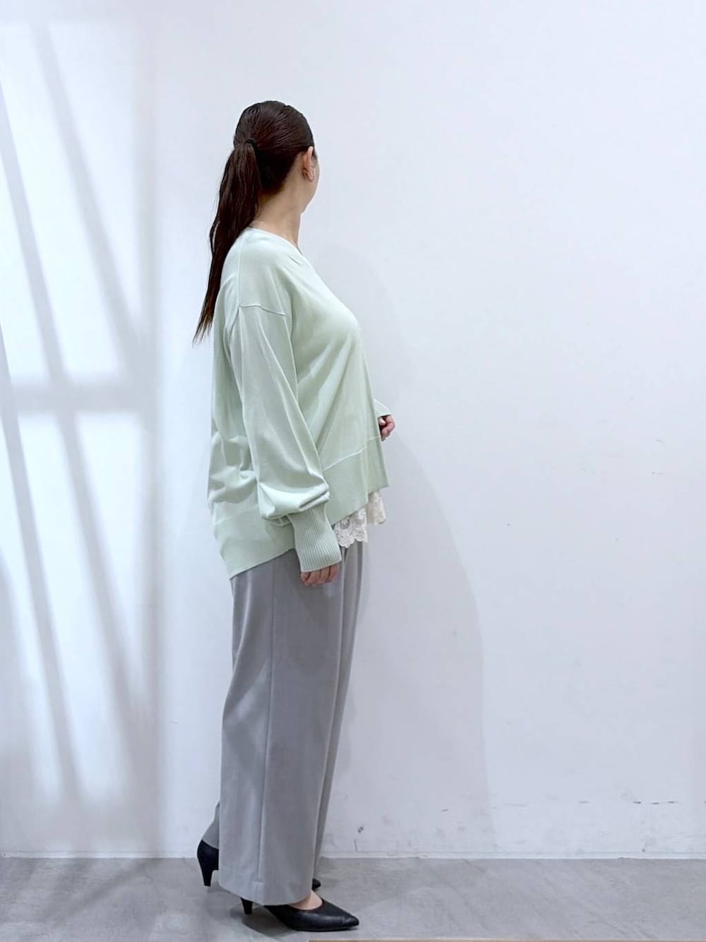 ホワイト系のタンクトップ、ブラック系のハンドバッグ、グレー系のその他パンツを着用したレディースの春コーディネートの5枚目の写真