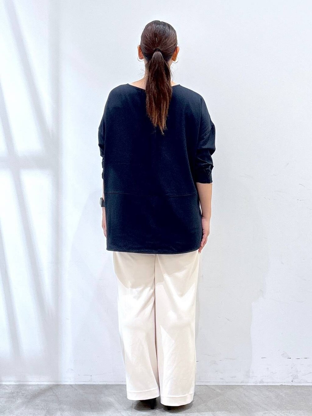 ブラック系のパンプス、ブルー系のシャツ/ブラウス、ブラック系のショルダーバッグを着用したレディースの秋コーディネートの4枚目の写真