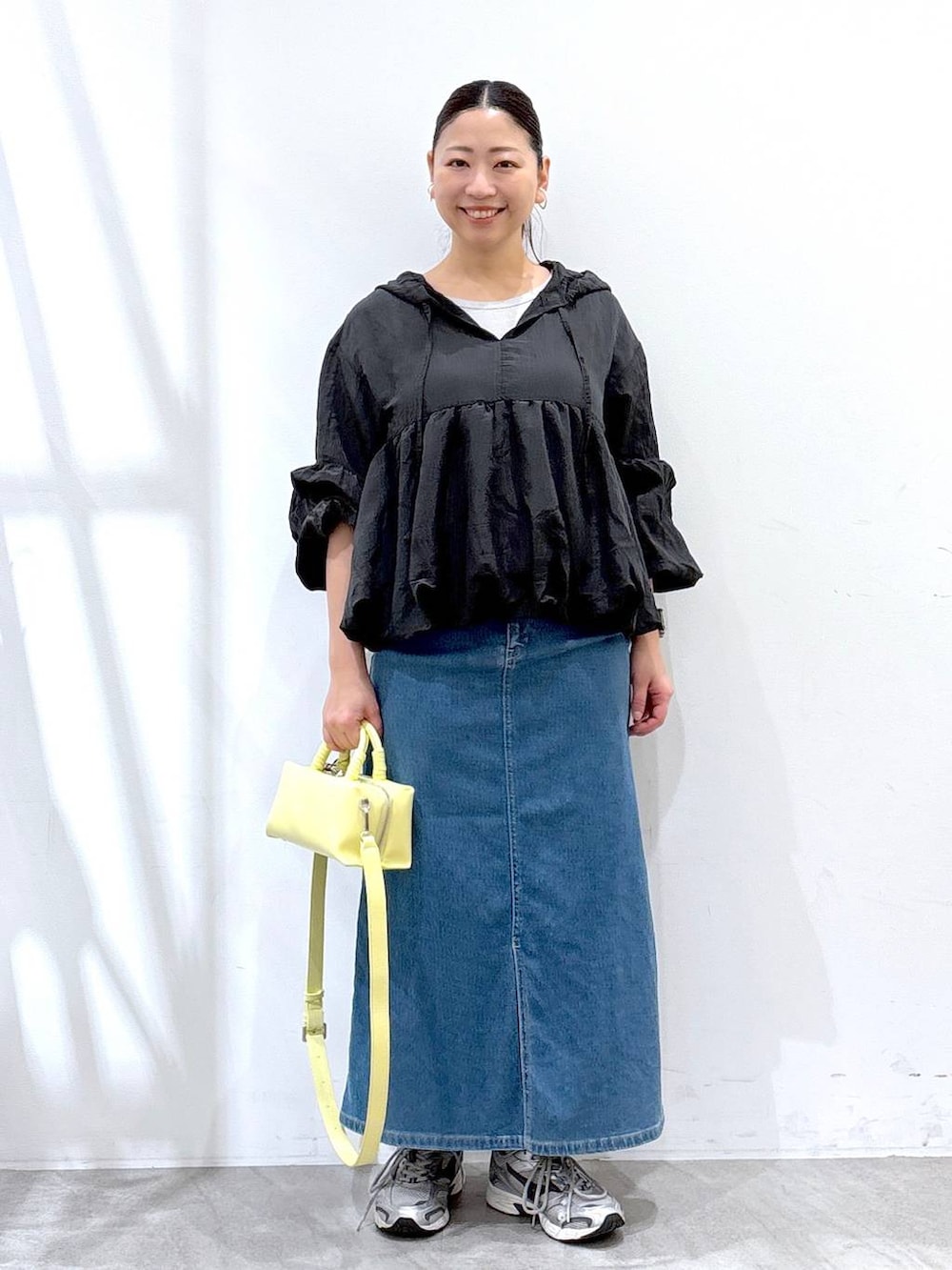 ホワイト系のTシャツ/カットソー、ブルー系のデニムスカート、ブラック系のTシャツ/カットソーを着用したレディースの春コーディネートの2枚目の写真