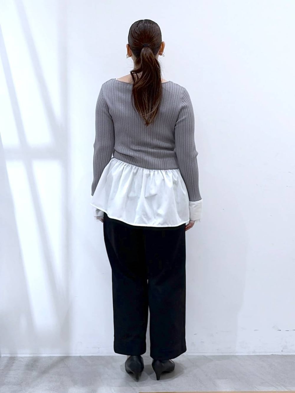 ブラック系のその他パンツ、ブラック系のハンドバッグ、ブルー系のカーディガン/ボレロを着用したレディースの春コーディネートの4枚目の写真