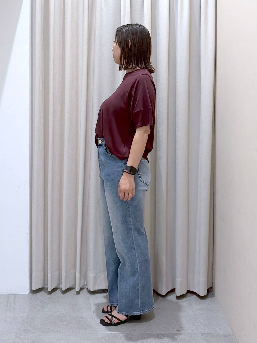 レッド系のTシャツ/カットソー、ブラック系のサンダル、ブルー系のデニムパンツを着用したレディースの夏コーディネートの3枚目の写真