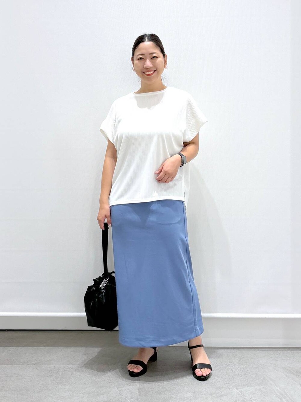 ホワイト系のTシャツ/カットソー、ブラック系のサンダル、ブルー系のスカートを着用したレディースの夏コーディネートの2枚目の写真