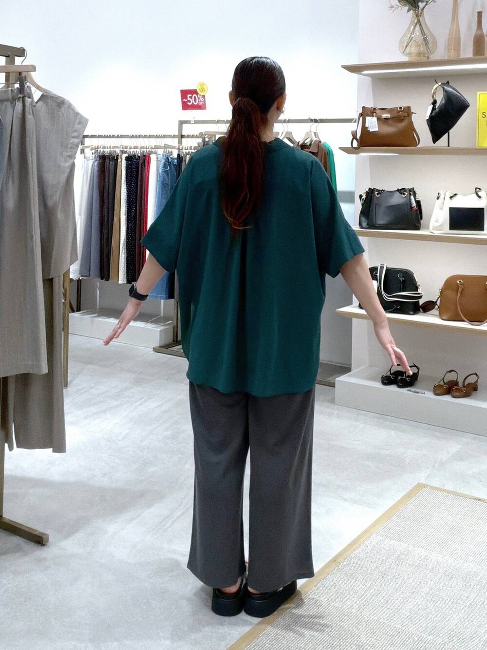 グレー系のその他パンツ、グリーン系のシャツ/ブラウス、ブラック系のタンクトップを着用したレディースの夏コーディネートの4枚目の写真