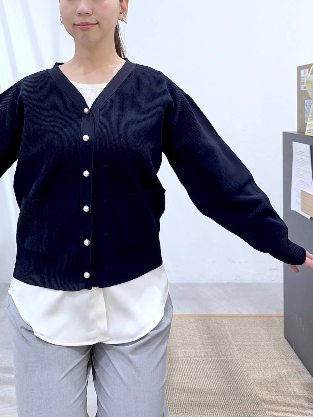 ブラック系のハンドバッグ、グレー系のその他パンツ、ブルー系のカーディガン/ボレロを着用したレディースの春コーディネートの7枚目の写真