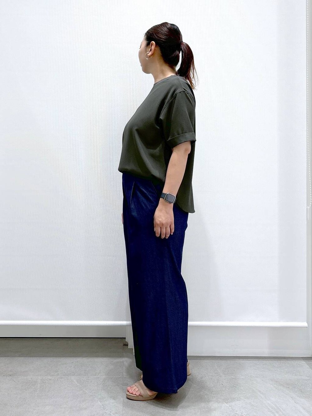 ブルー系のデニムパンツ、ベージュ系のサンダル、ブルー系のデニムパンツを着用したレディースの夏コーディネートの3枚目の写真