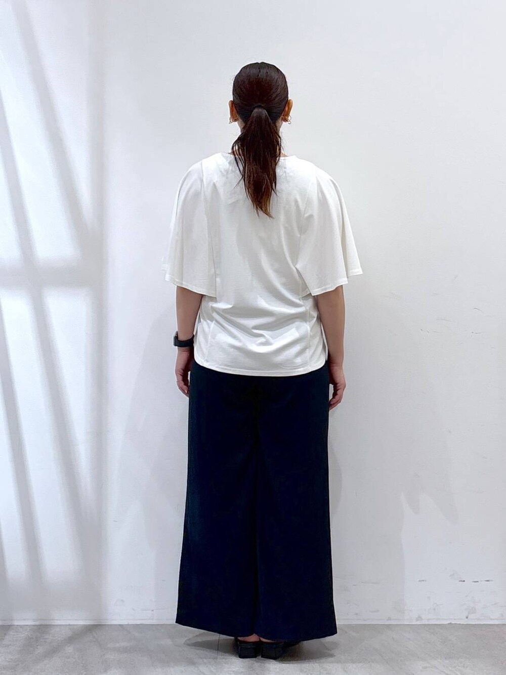 ブルー系のその他パンツ、ブラック系のサンダル、シルバー系のトートバッグを着用したレディースの夏コーディネートの4枚目の写真
