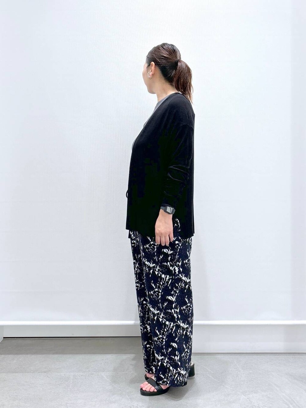 ブラック系のトートバッグ、ブルー系のその他パンツ、ブラック系のサンダルを着用したレディースの夏コーディネートの3枚目の写真