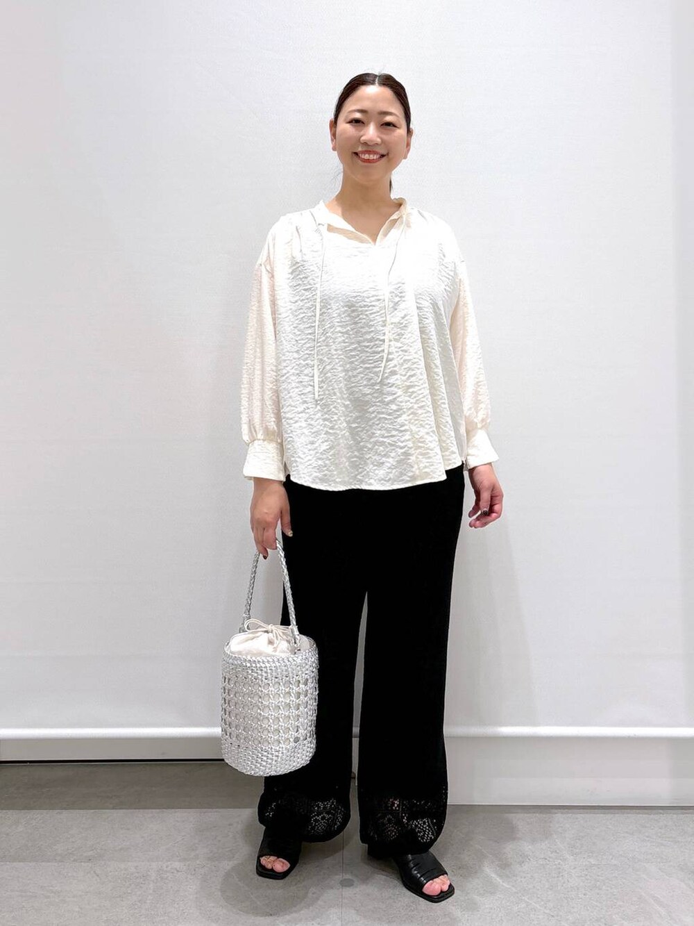 ホワイト系のシャツ/ブラウス、ブラック系のサンダルを着用したレディースの春コーディネートの2枚目の写真