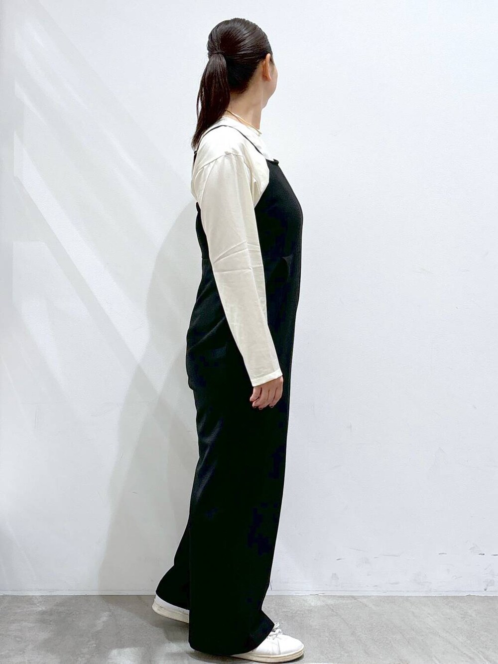 ホワイト系のシャツ/ブラウス、ブラック系のサロペット/オーバーオールを着用したレディースの秋コーディネートの5枚目の写真