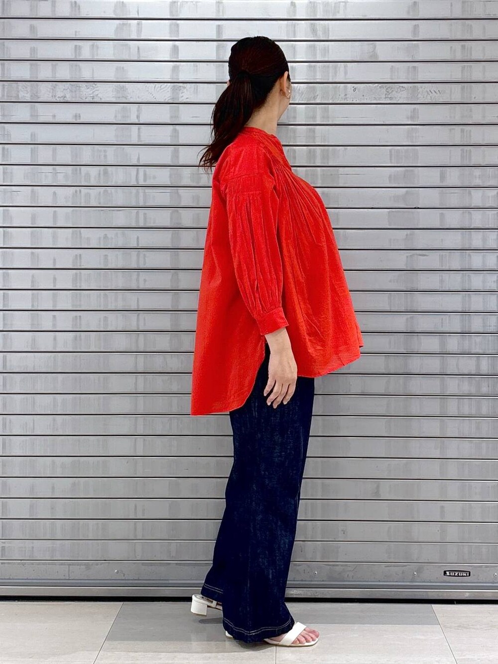 レッド系のシャツ/ブラウス、グレー系のその他パンツ、ホワイト系のハンドバッグを着用したレディースの春コーディネートの5枚目の写真