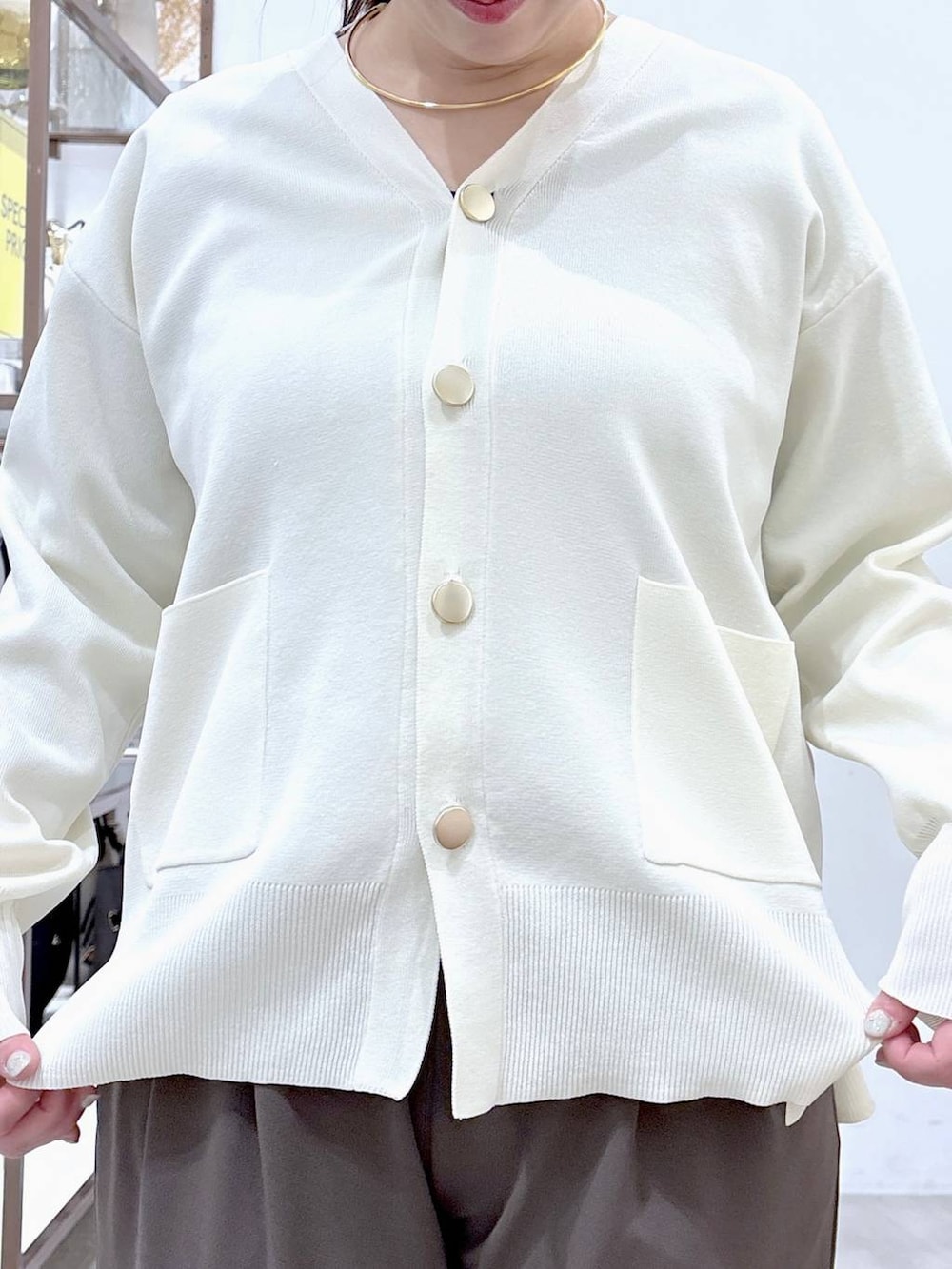 ホワイト系のカーディガン/ボレロ、ブラウン系のその他パンツ、ブラック系のハンドバッグを着用したレディースの冬コーディネートの7枚目の写真