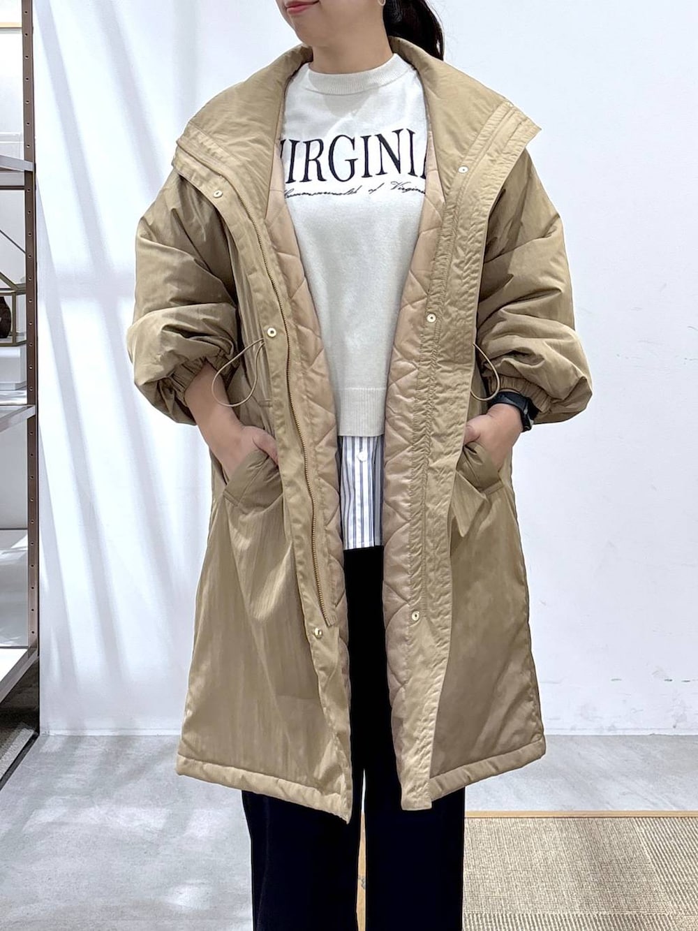 グレー系のスニーカー、イエロー系のダウンジャケット/コート、ベージュ系のTシャツ/カットソーを着用したレディースの秋コーディネートの3枚目の写真