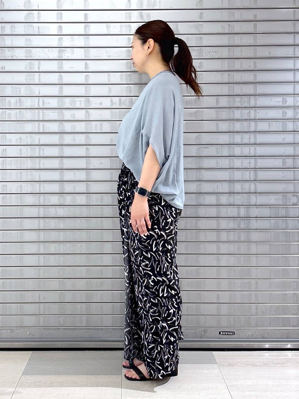 ブラック系のその他パンツ、ブルー系のTシャツ/カットソー、ブラック系のハンドバッグを着用したレディースの春コーディネートの3枚目の写真